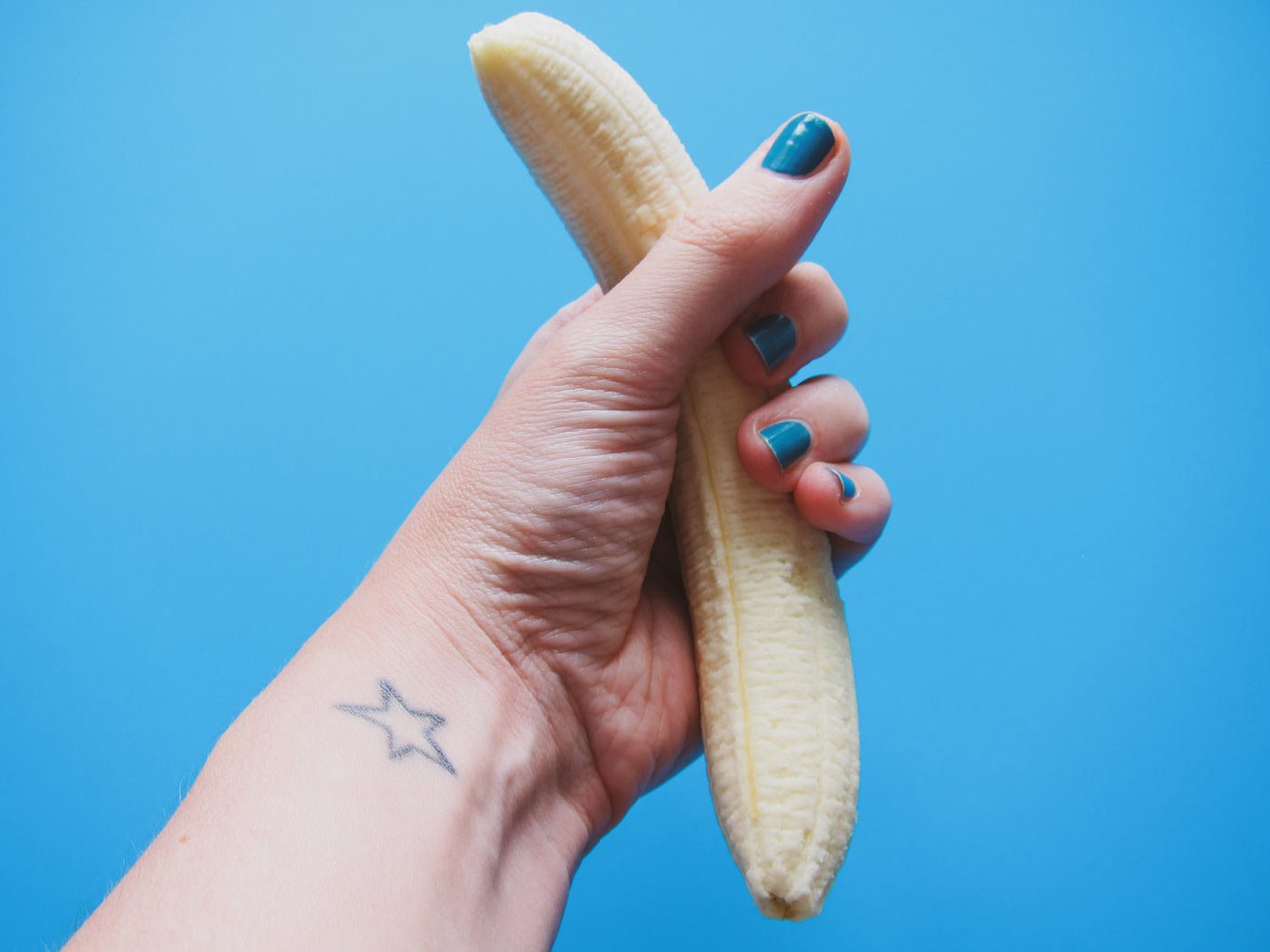 Hand squeezing banana